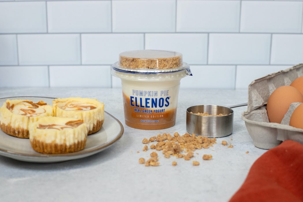 From left to right: Ellenos Pumpkin Pie Mini Cheesecakes (left), a cup of Ellenos Pumpkin Pie Greek yogurt (center left), a scoop of Ellenos Pumpkin Pie crumble (center right), and eggs (right)