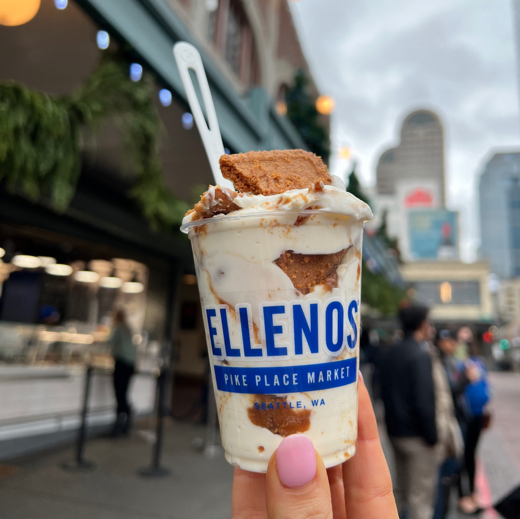 Walkaround cup of Ellenos Biscoff Cookie Butter Greek yogurt held outside of Pike Place Market scoop shop.